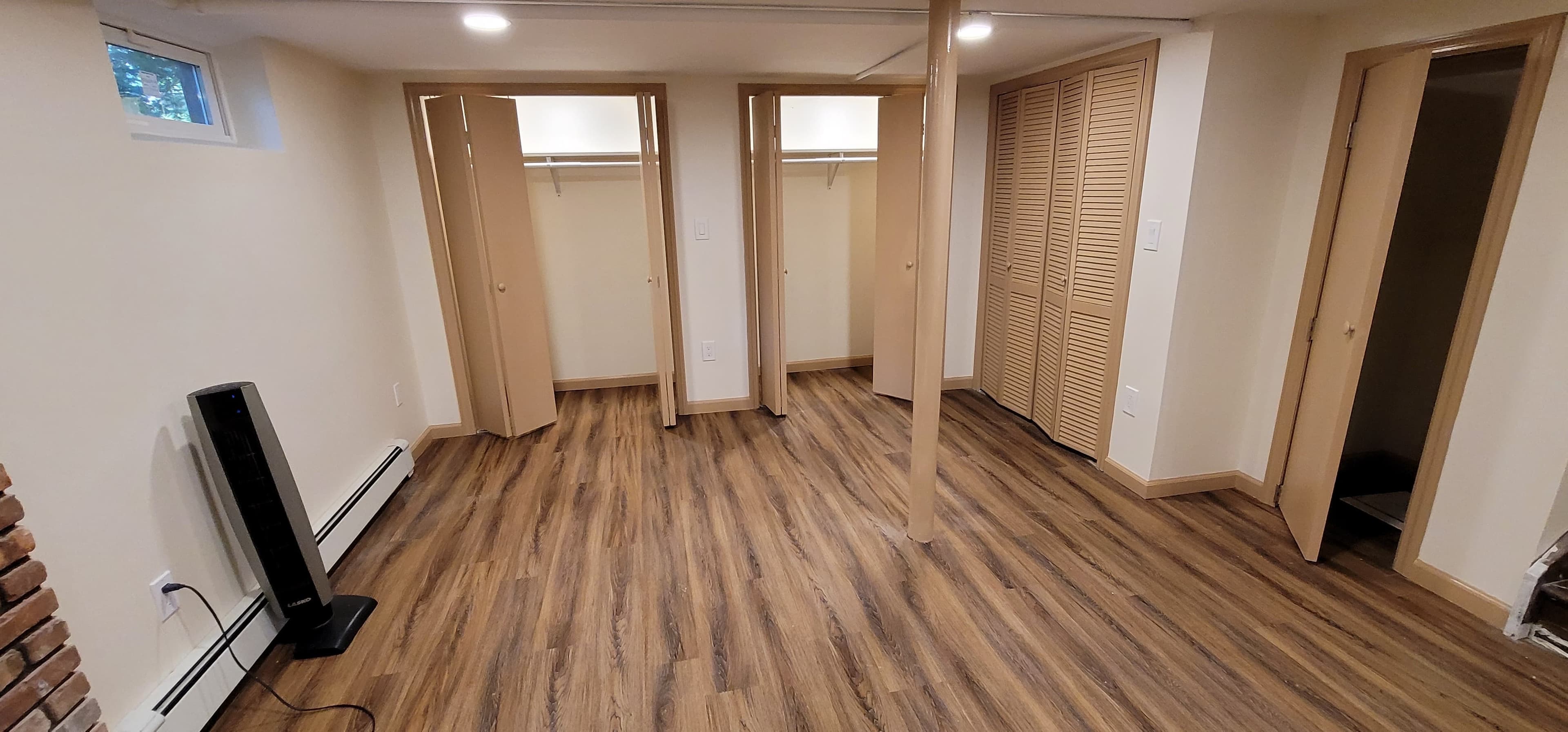 Finished basement apartment with bi-fold closets, LVP flooring, and recessed lighting in Rockland County NY