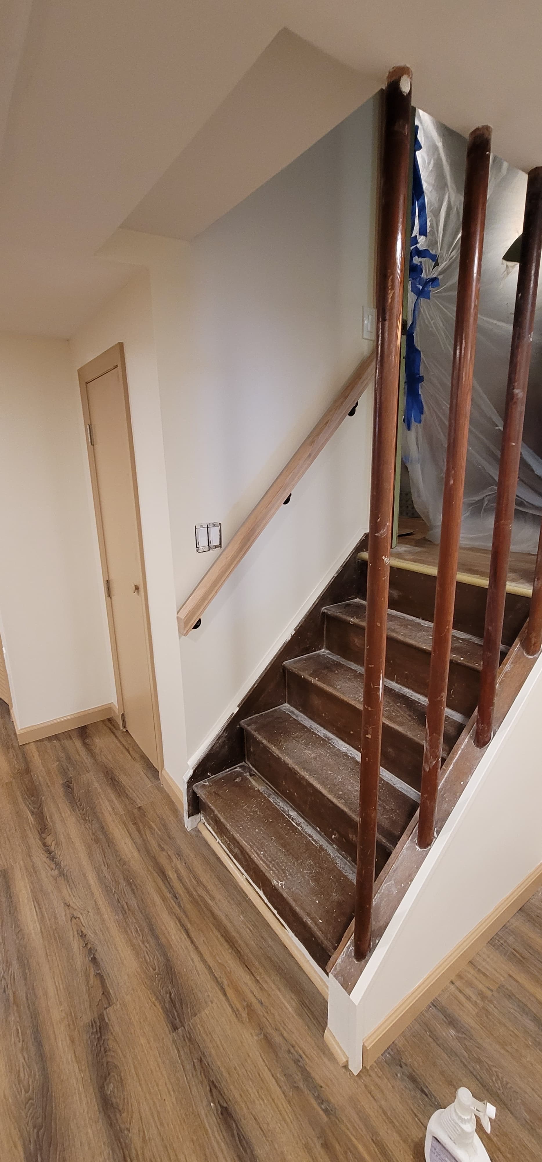 Basement staircase with LVP flooring and utility door near project completion, Rockland County NY