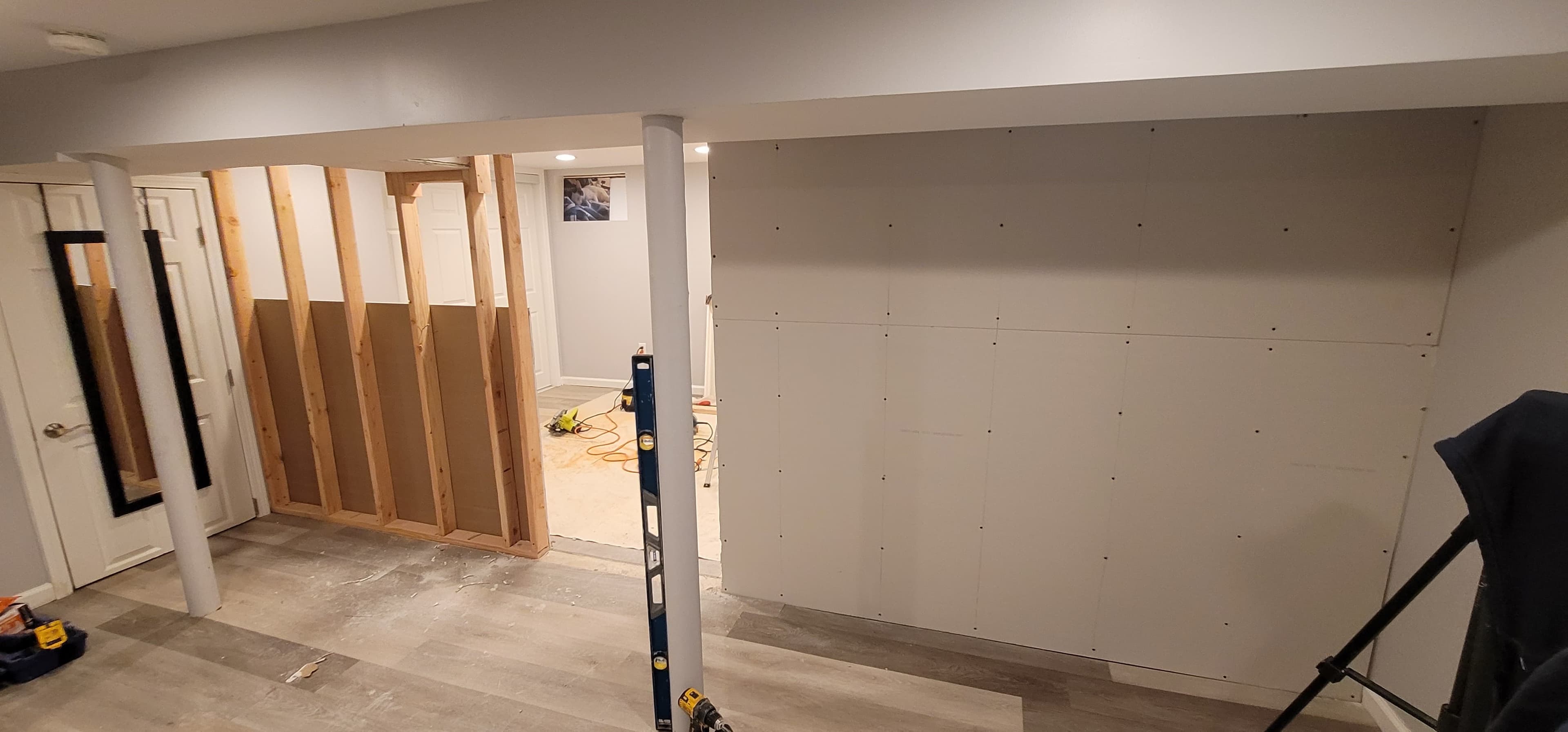 Basement finishing in progress — wood stud framing and LVP flooring installation, Rockland County NY
