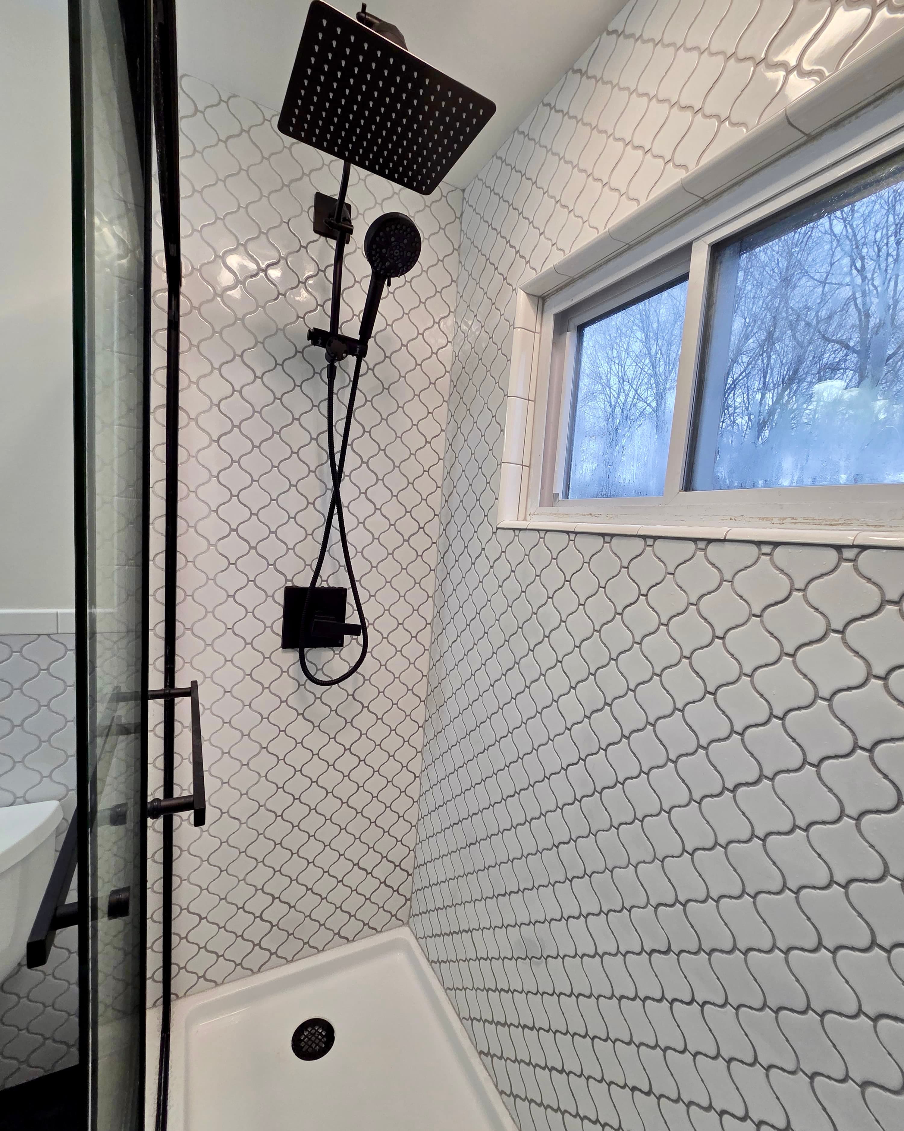 Custom shower with arabesque tile and black rain shower head, Rockland County NY