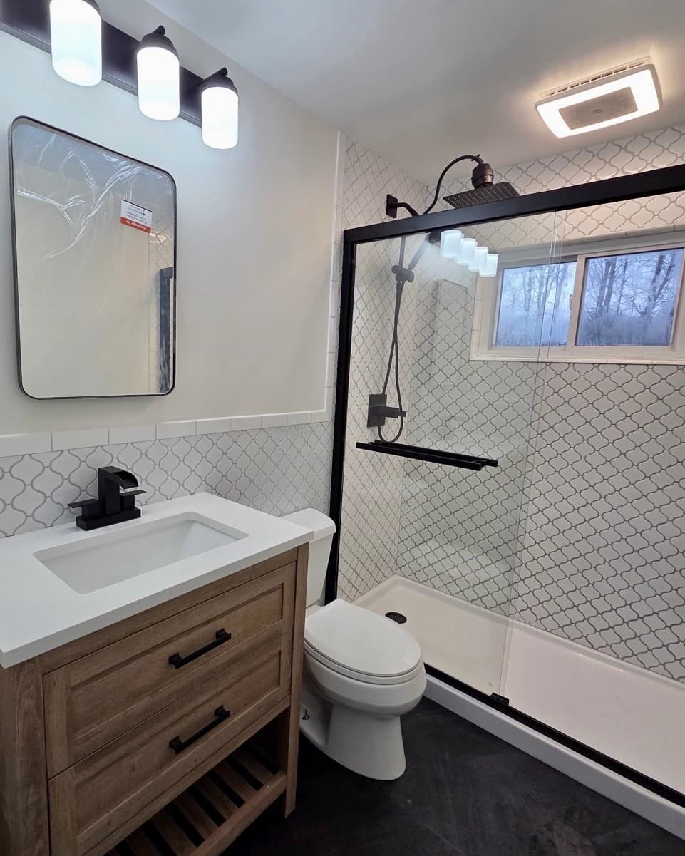 Bathroom remodel with arabesque tile, wood vanity and black fixtures by Q's Home Improvement, Rockland County, NY