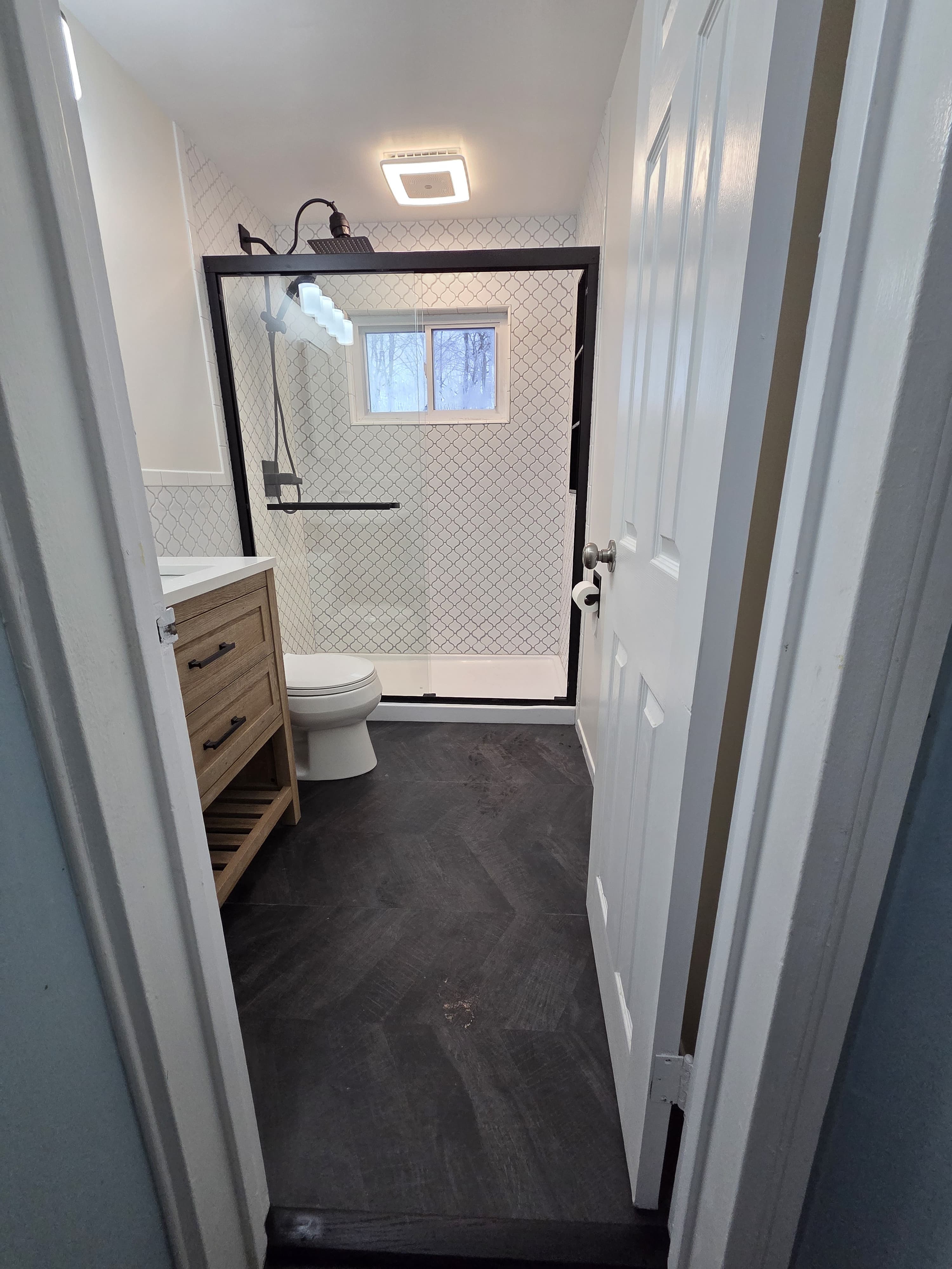 After bathroom renovation — arabesque tile shower with glass door and wood vanity, Rockland County NY