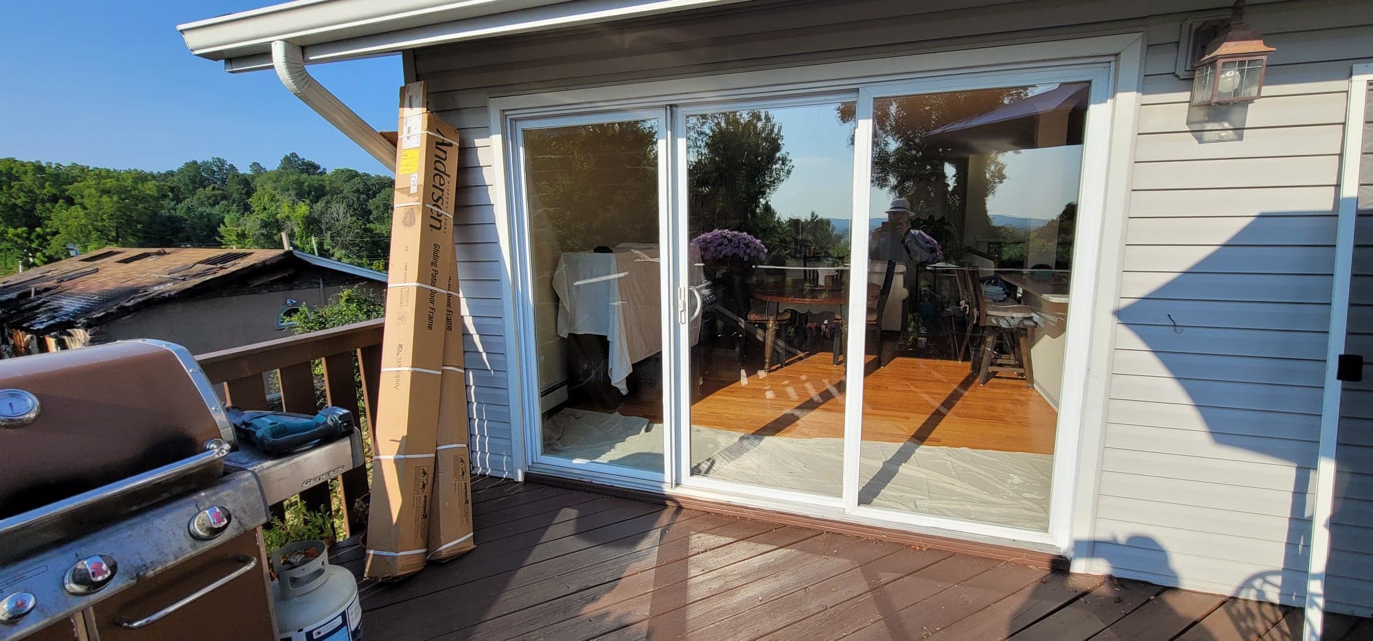 New Andersen white sliding patio door installed, view from deck into dining room, Rockland County NY